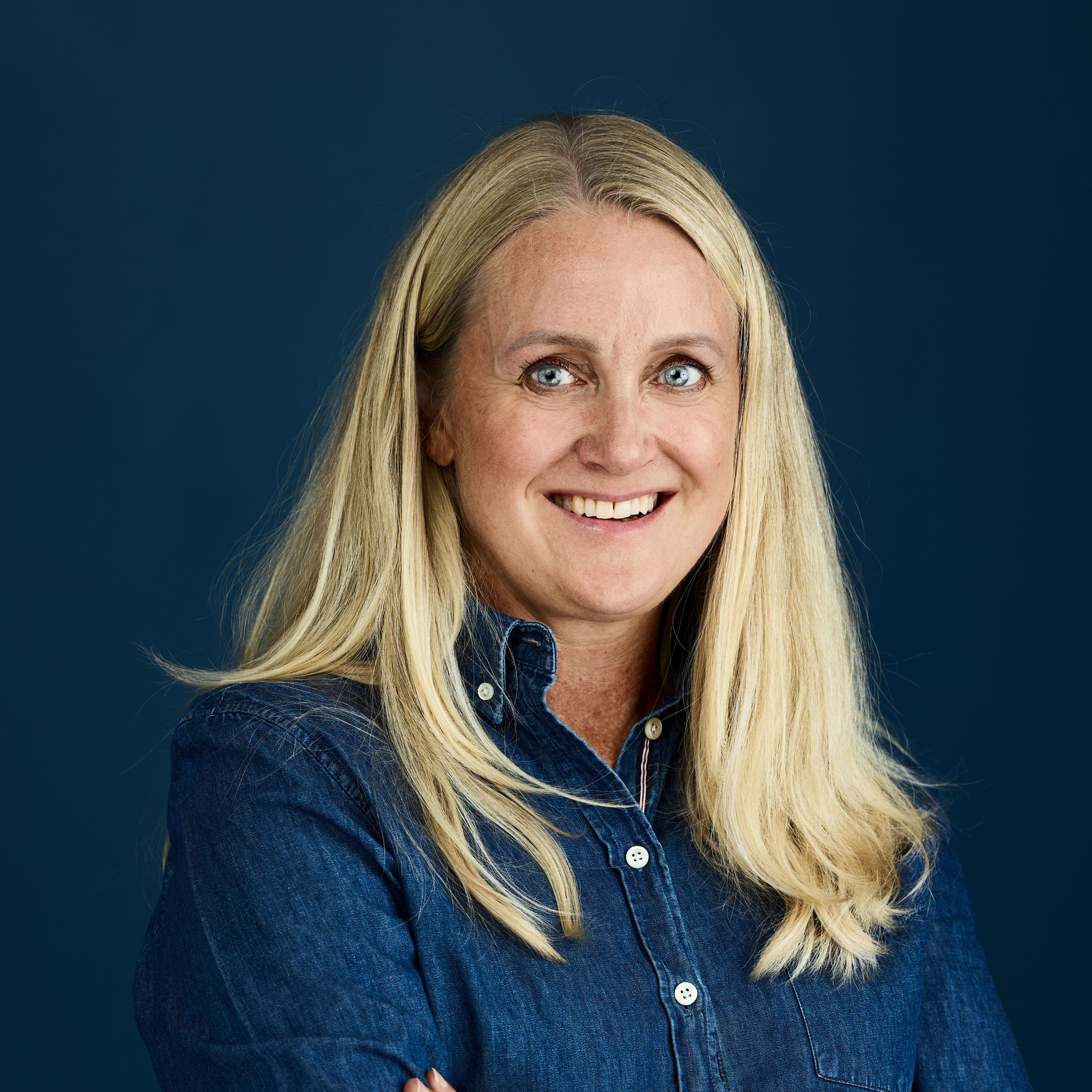 Portrait of Christine Wiig against a dark blue backdrop