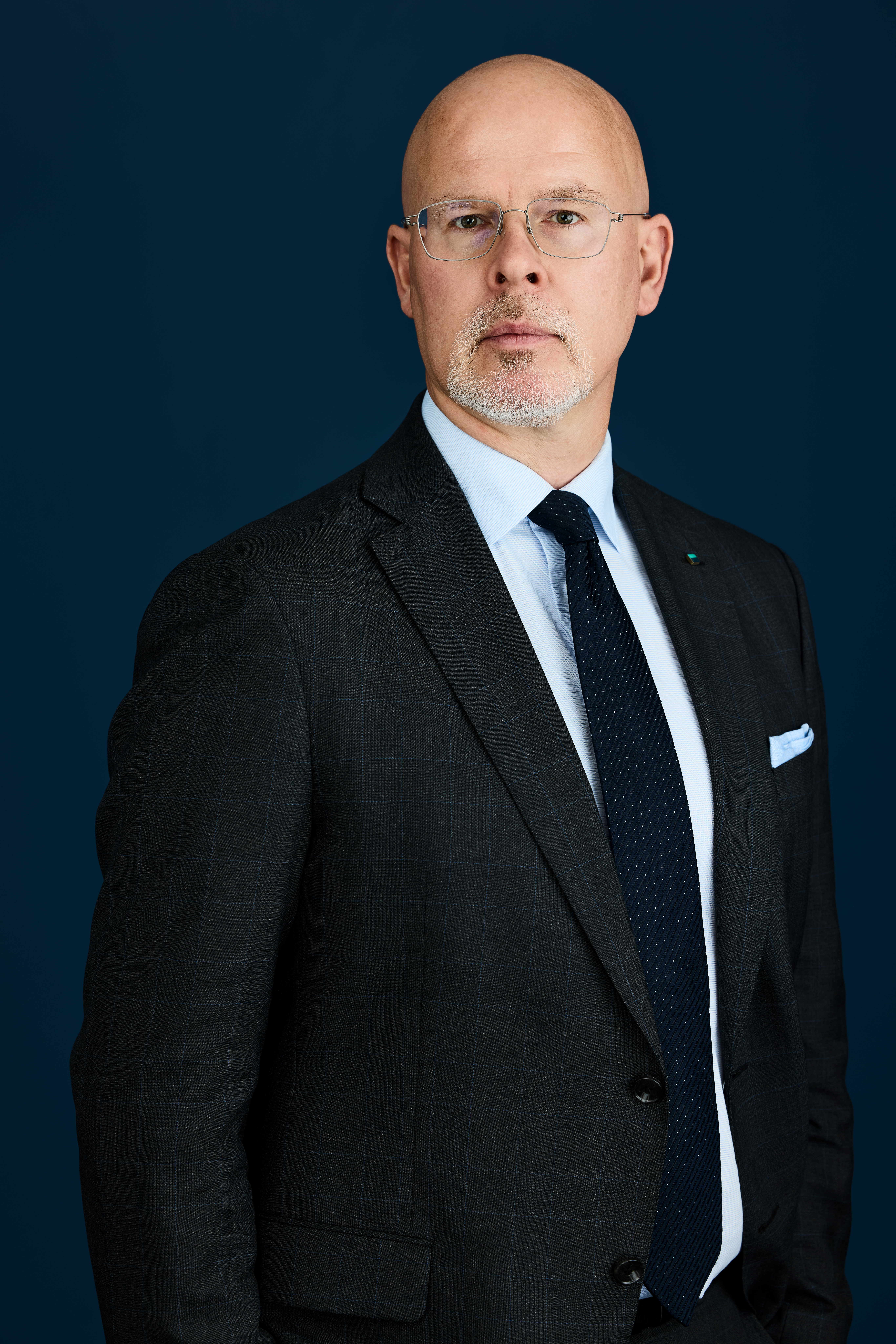 Portrett av Audun Halvorsen mot mørkblå bakgrunn 