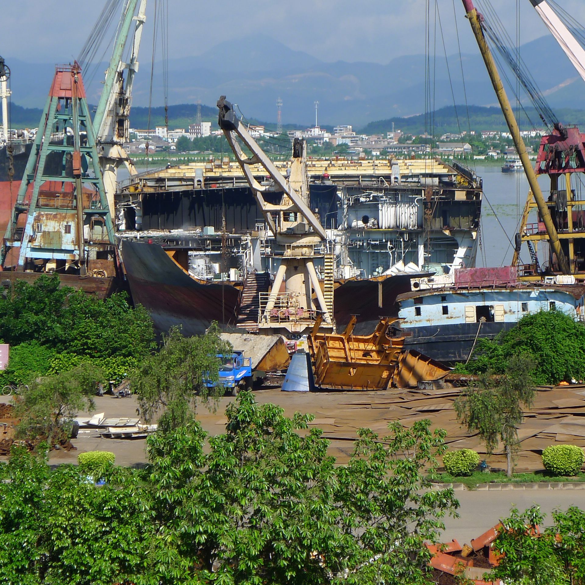 Photo from a ship recycling yard - a blue ship being dismantled