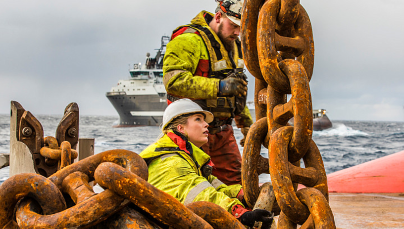 One male and one female working on the deck of an AHTS 