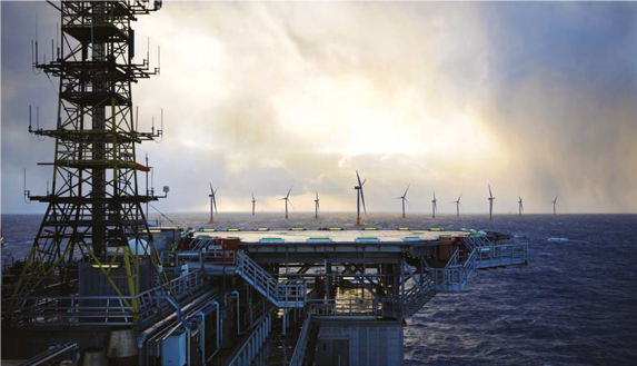 wind turbines with a vessel with helideck in the foreground 