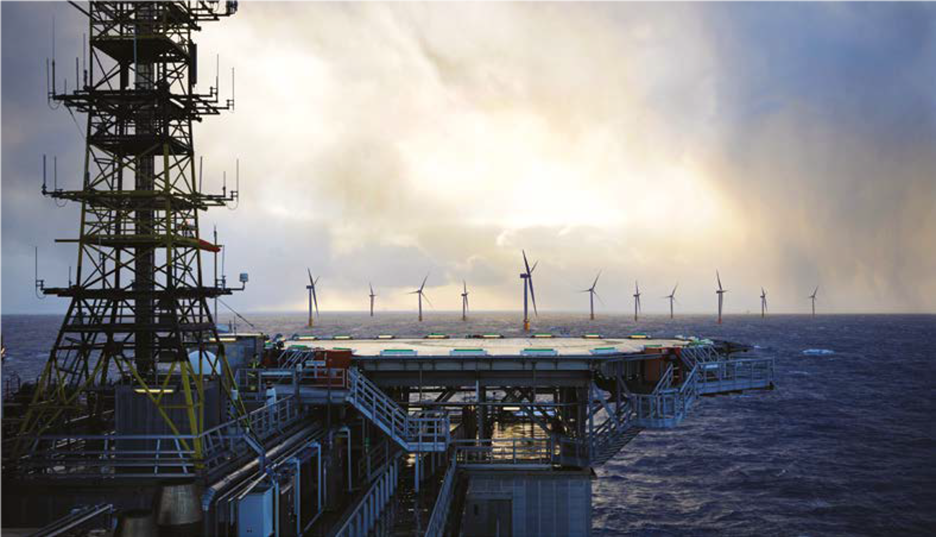 wind turbines with a vessel with helideck in the foreground